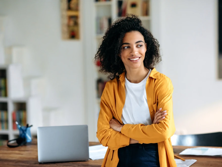 A smiling woman filling out new patient forms at home