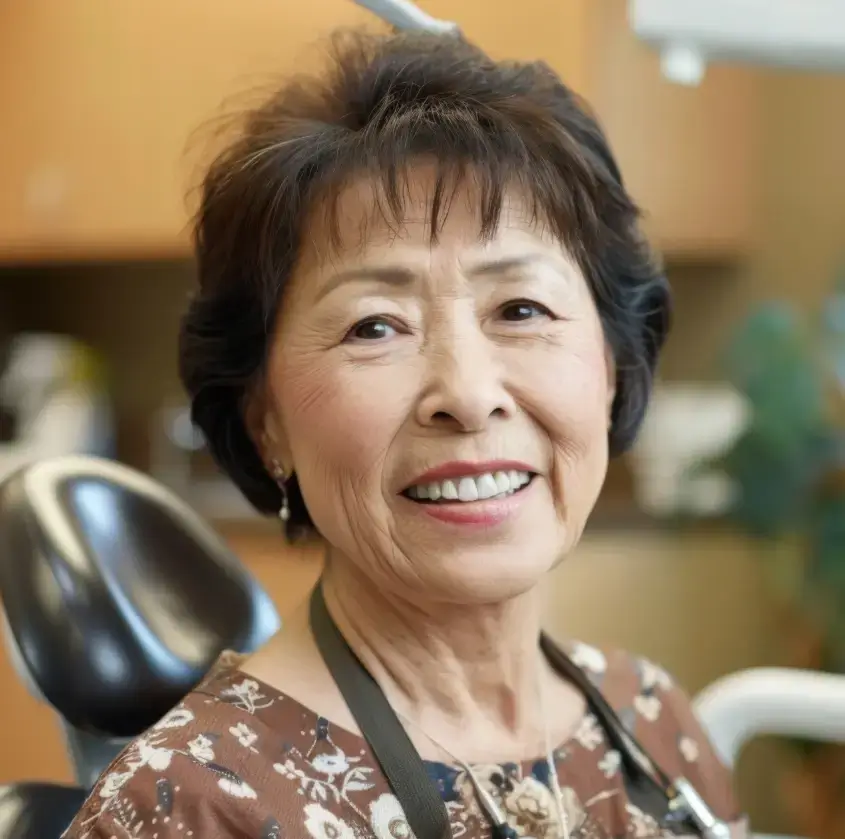 A smiling senior woman in the dental chair