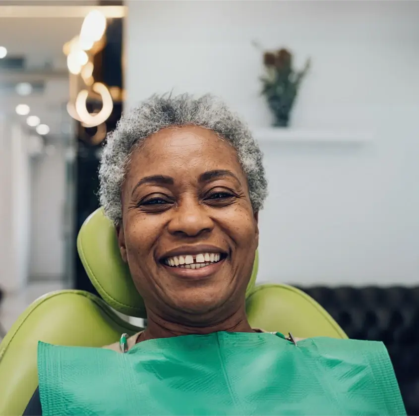 A smiling senior woman in the dental chair