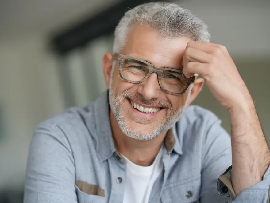A smiling older man with glasses