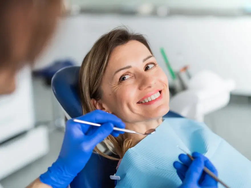 A smiling patient in the dental chair during an exam