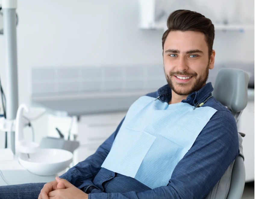 A smiling man seated in the dental chair