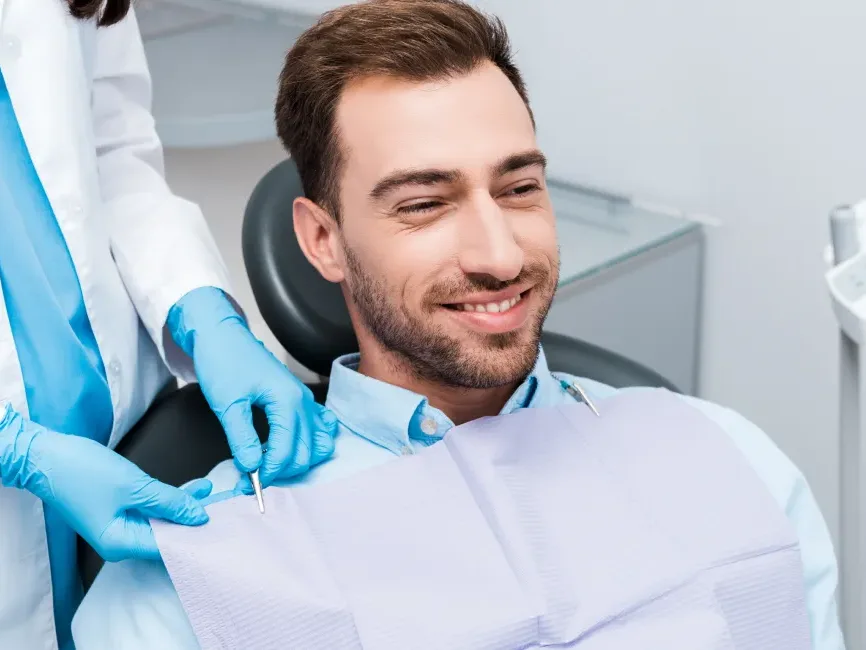 A smiling patient in the dental chair during a restorative visit
