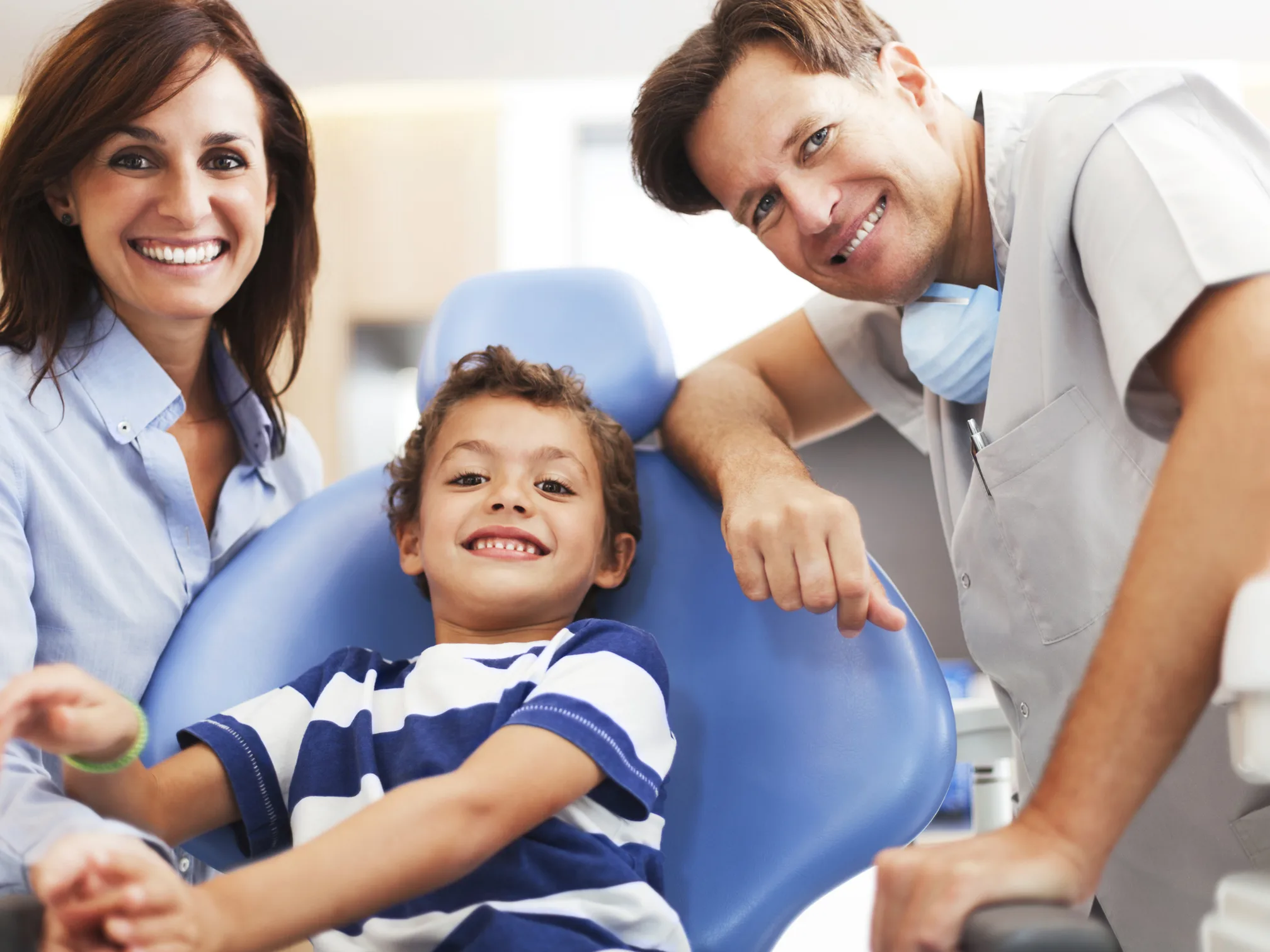 A family of patients smiling together at the practice