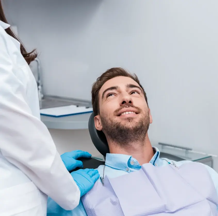 A relaxed patient reclining in the dental chair