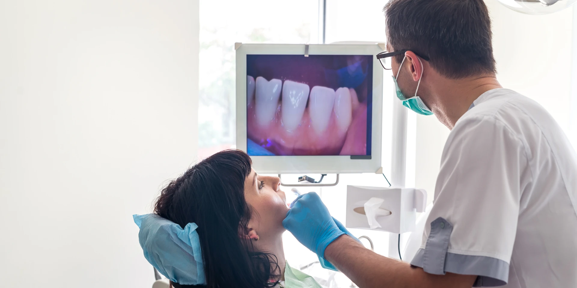A dentist reviewing a digital scan with a patient