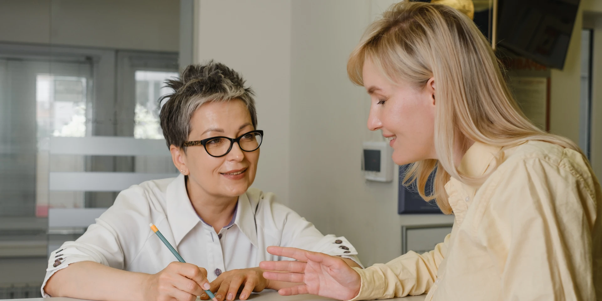 A team member welcoming a patient at the front desk